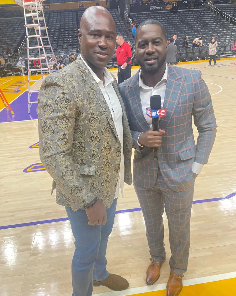 Gary Durrant courtside at an NBA arena with a television reporter