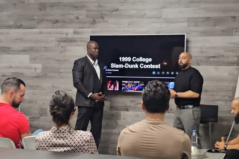 Gary Durrant presenting in front of a screen showing the 1999 College Slam Dunk Contest